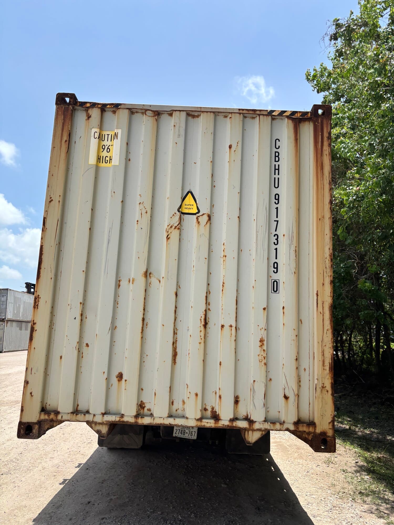Rear doors of a used 40ft high-cube container on a trailer showing surface rust on frames and corrugation