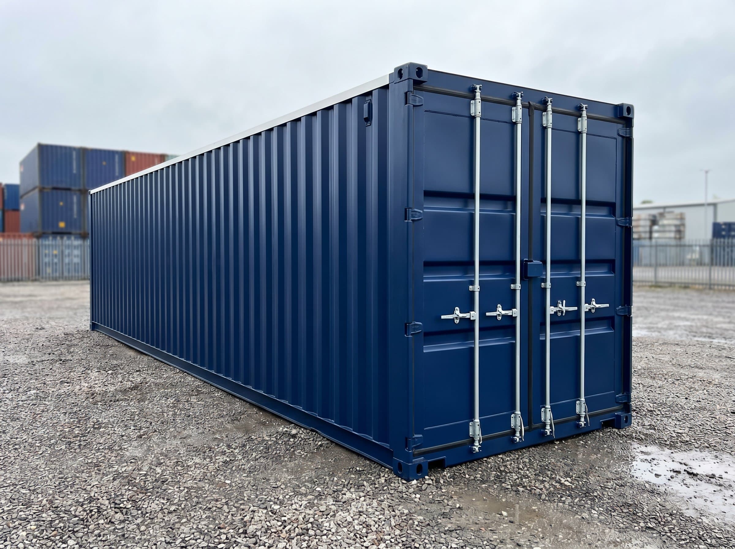 Pristine brand-new 40ft high-cube one-trip shipping container in factory navy blue, white high-cube stripe, cargo doors closed