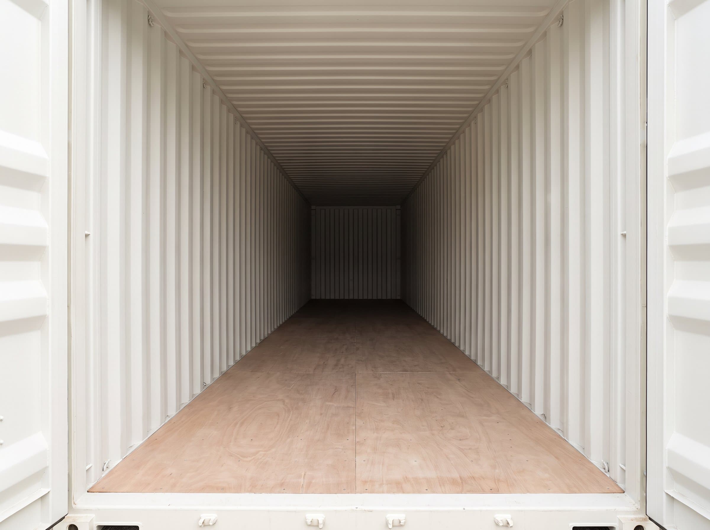 Interior view looking down the length of a brand-new 40ft high-cube one-trip shipping container with tall pristine interior